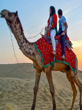 Camel safari ride in Jaisalmer desert – traditional Rajasthan experience at sunset